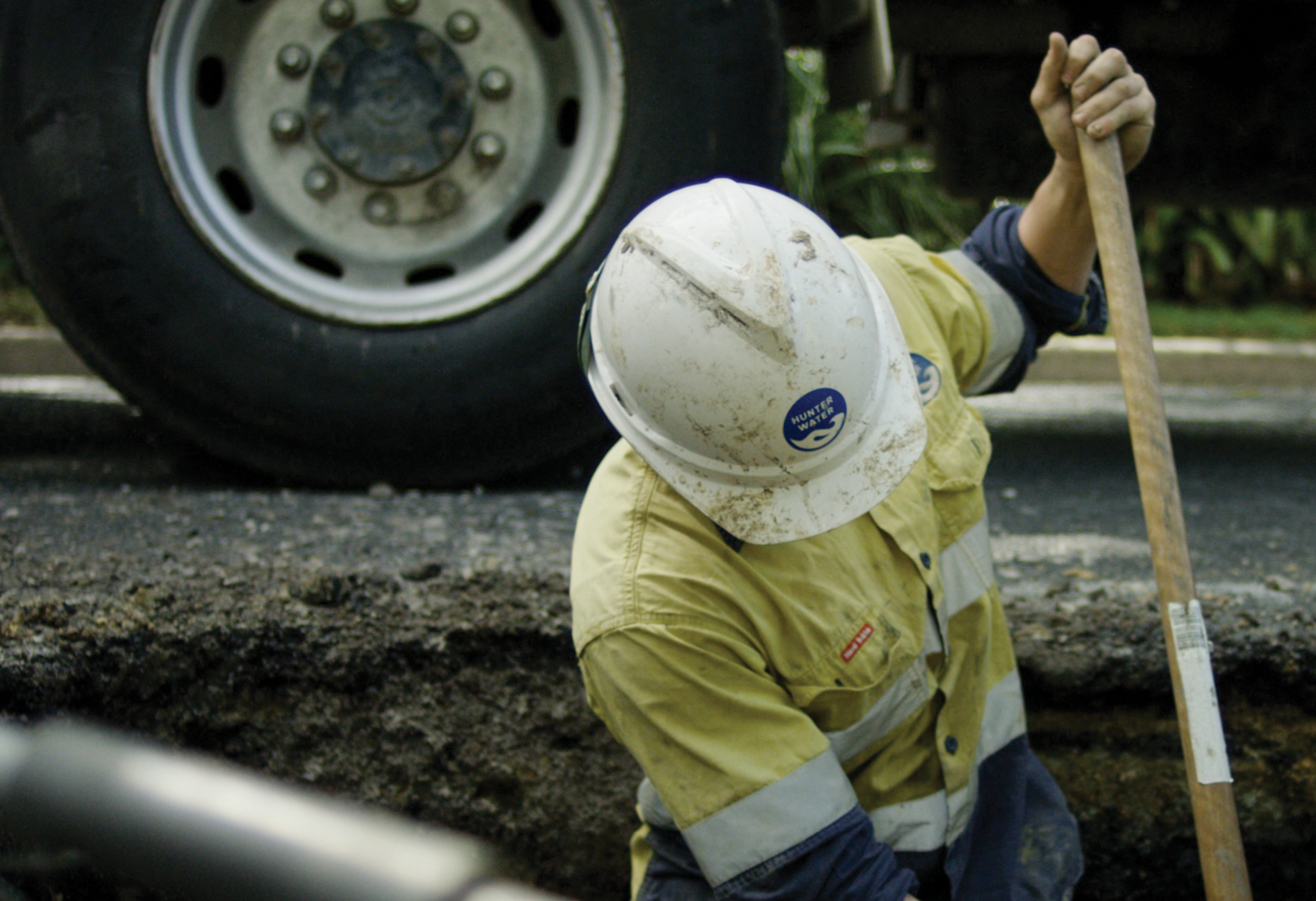 A field worker digging in a trench