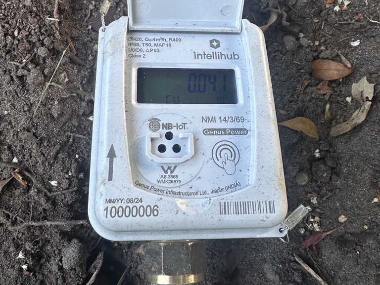 white digital water meter reader in situ