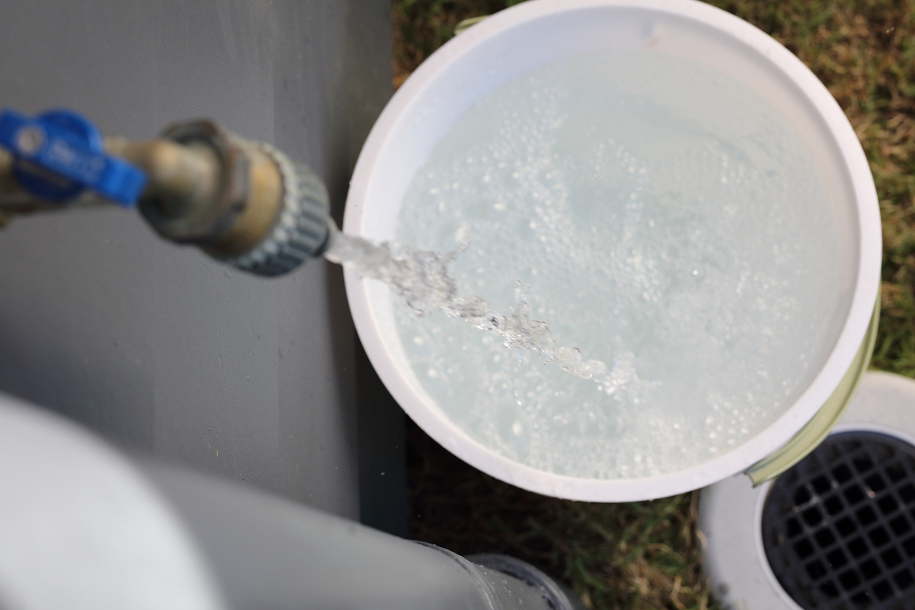 a tap with clean water running into a bucket