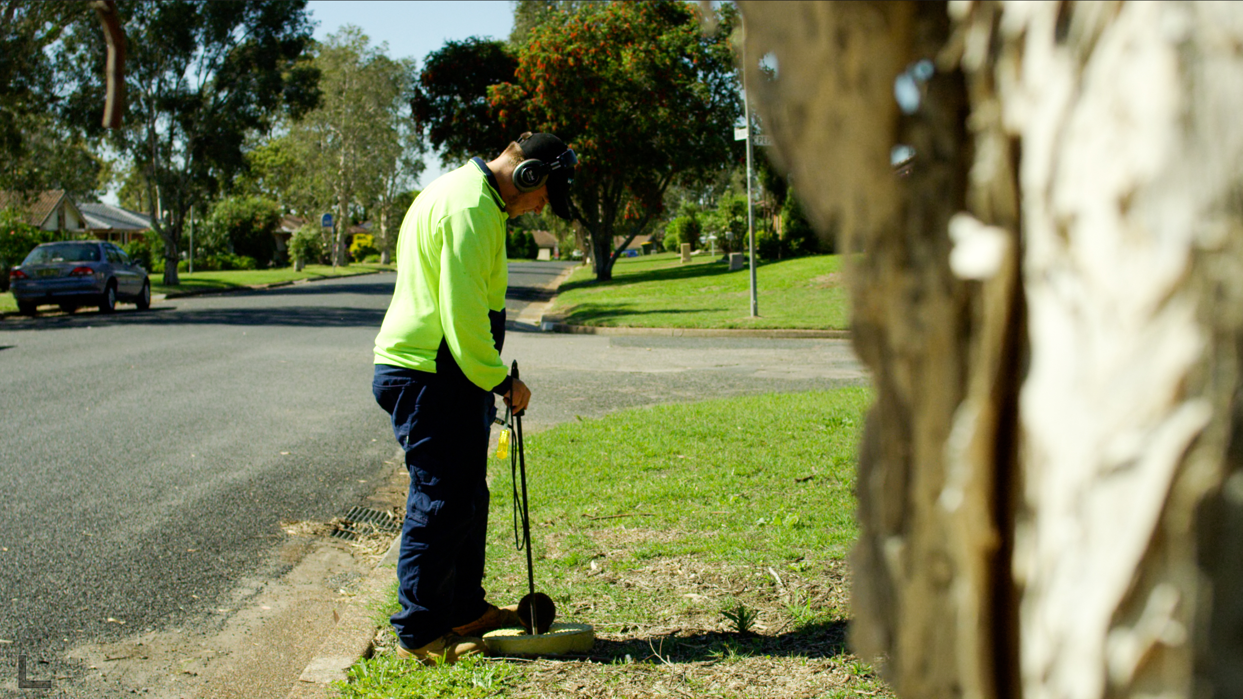 Worker using a listening stick to monitor the pipe network for leaks